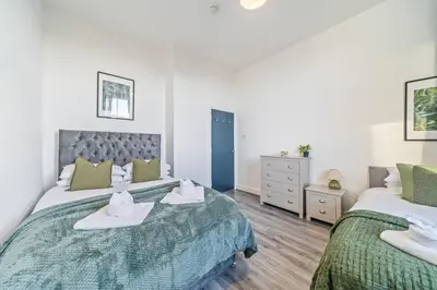 a bedroom with two beds with towels on them at Latimer Flat 3 - Spacious 2-Bed Apt - Sleeps 6 in Liverpool