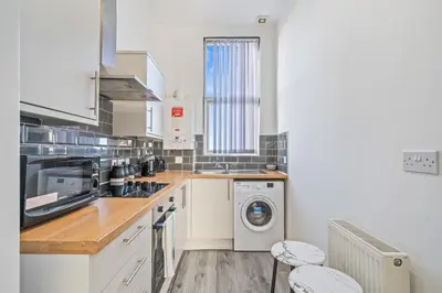 a kitchen with a washer and dryer at Latimer Flat 4 - Spacious 2-Bed Apt - Sleeps 6 in Liverpool