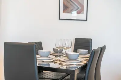 a dining room table with a black table and chairs at Latimer Flat 4 - Spacious 2-Bed Apt - Sleeps 6 in Liverpool