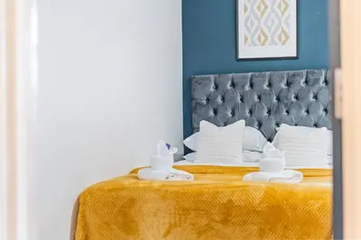 a bed with two towels on top of it at Latimer Flat 5 - Spacious 2-Bed Apt - Sleeps 7 in Liverpool