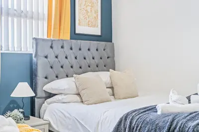 a bedroom with a large bed with white pillows at Latimer Flat 5 - Spacious 2-Bed Apt - Sleeps 7 in Liverpool