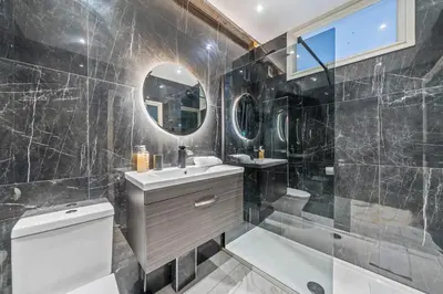 a bathroom with a sink and a toilet and a mirror at Latimer Flat 5 - Spacious 2-Bed Apt - Sleeps 7 in Liverpool