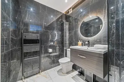 a bathroom with a toilet and a sink and a mirror at Latimer Flat 5 - Spacious 2-Bed Apt - Sleeps 7 in Liverpool