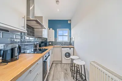 a kitchen with a washer and dryer at Latimer Flat 6 - Spacious 2-Bed Apt - Sleeps 7 in Liverpool