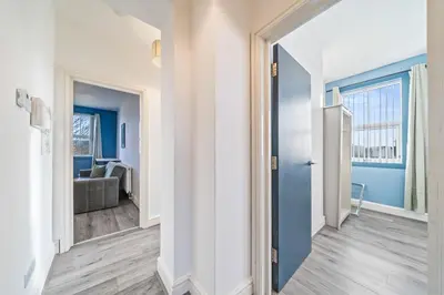 a hallway with a door leading to a living room at Latimer Flat 6 - Spacious 2-Bed Apt - Sleeps 7 in Liverpool