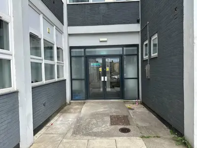 an entrance to a building with a glass door at Melbourne House Apartment Near Train Station! in Accrington