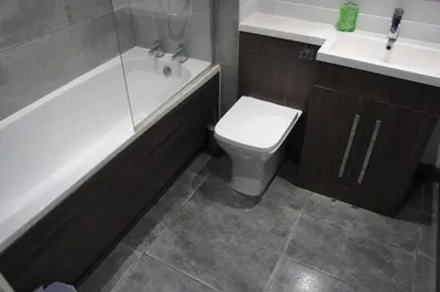 a bathroom with a toilet and a tub and a sink at Melbourne House Apartment Near Train Station! in Accrington