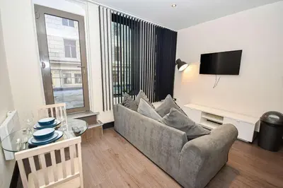 a living room with a couch and a table at Modern & Cosy 2BED Apartment in Central Liverpool in Liverpool
