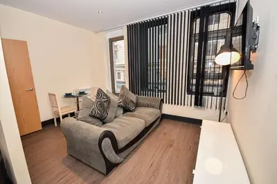 a living room with a couch and a table at Modern & Cosy 2BED Apartment in Central Liverpool in Liverpool