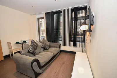 a living room with a couch and a table at Modern & Cosy 2BED Apartment in Central Liverpool in Liverpool