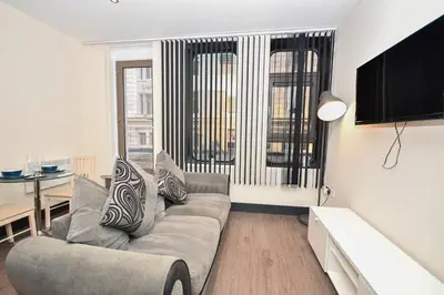 a living room with a couch and a table at Modern & Cosy 2BED Apartment in Central Liverpool in Liverpool