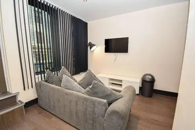 a living room with a couch and a tv at Modern & Cosy 2BED Apartment in Central Liverpool in Liverpool