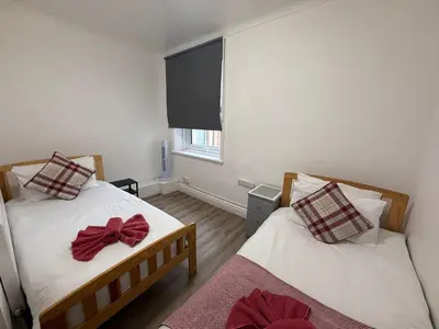 a bedroom with two beds with bows on them at Blackpool - Apartment - Sleeps 6- Coastal Stay in Blackpool