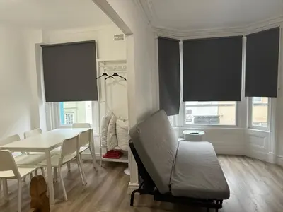 a living room with a table and a chair at Blackpool - Apartment - Sleeps 6- Coastal Stay in Blackpool