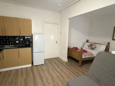 a small kitchen with a white refrigerator and a bed at Blackpool - Apartment - Sleeps 6- Coastal Stay in Blackpool