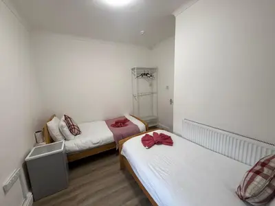 a room with two beds with red bows on them at Blackpool - Apartment - Sleeps 6- Coastal Stay in Blackpool