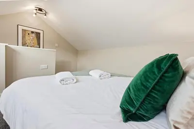 a bedroom with a white bed with green pillows at Stunning 3B Home, ideal for leisure & contractors in Clitheroe