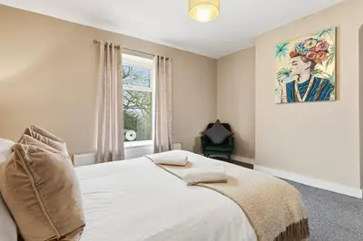 a bedroom with a white bed and a window at Stunning 3B Home, ideal for leisure & contractors in Clitheroe