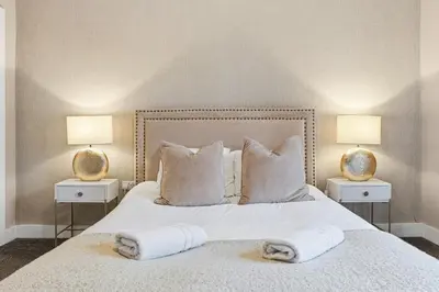 a bedroom with a white bed with two lamps at Stunning 3B Home, ideal for leisure & contractors in Clitheroe