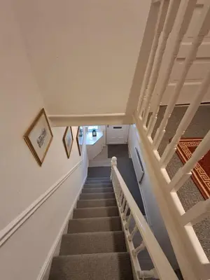 a stairway in a house with white walls and stairs at 16 Skipton Road in Liverpool
