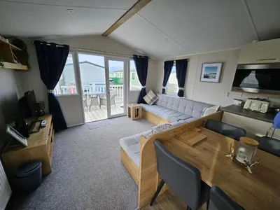 a living room with a couch and a table at Rendezvous at Ocean Edge in Heysham