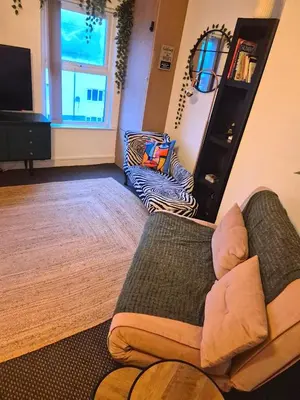 a living room with a couch and a mirror at COZY Apartment 4 in Liverpool