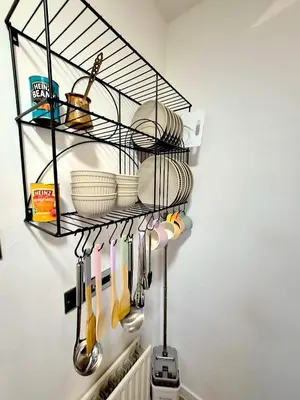 a rack with dishes and utensils in a kitchen at COZY Apartment 4 in Liverpool