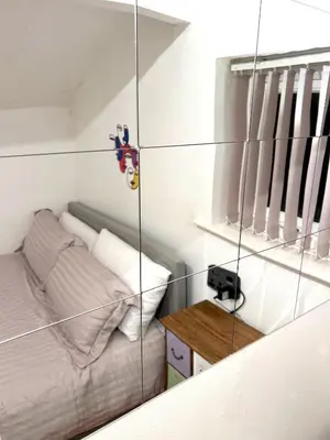 a small bedroom with a bed and a table at COZY Apartment 4 in Liverpool
