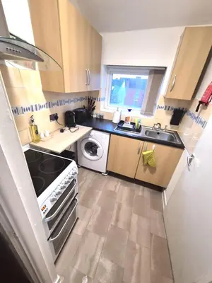 a small kitchen with a sink and a washing machine at COZY Apartment 4 in Liverpool
