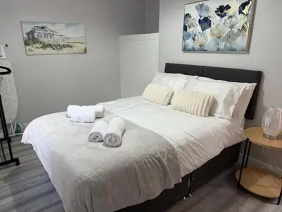 a bedroom with a bed with towels on it at Adrian House Blackpool in Blackpool