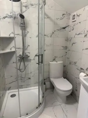 a bathroom with a toilet and a glass shower at Adrian House Blackpool in Blackpool