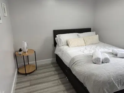 a bedroom with a bed with two towels on it at Adrian House Blackpool in Blackpool