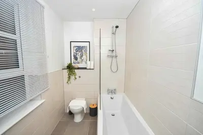 a bathroom with a toilet and a bath tub at Modern 2 Bedroom Apartment in Central Wigan in Wigan