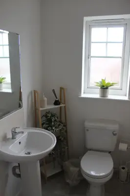 a bathroom with a toilet and a sink and a window at Whole House in Liverpool, Merseyside in Liverpool