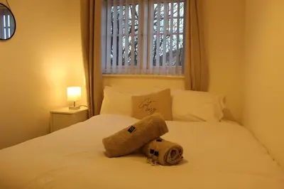 a towel on top of a bed with a window at Whole House in Liverpool, Merseyside in Liverpool