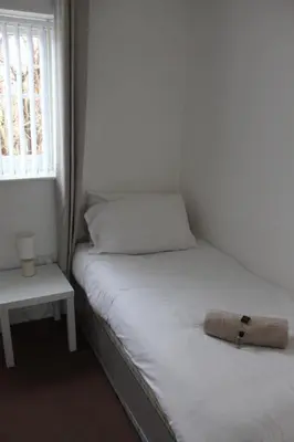 a small bedroom with two beds and a window at Whole House in Liverpool, Merseyside in Liverpool