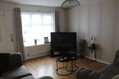 a living room with a couch and a television at Whole House in Liverpool, Merseyside in Liverpool