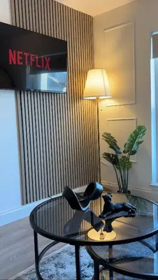 a living room with a table and a chair at Liverpool Central City Centre Modern Apartment - Sleeps 4 in Liverpool