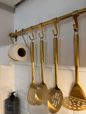 a group of kitchen utensils hanging from a rack at Liverpool Central City Centre Modern Apartment - Sleeps 4 in Liverpool