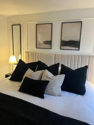 a bedroom with a bed with black and white pillows at Liverpool Central City Centre Modern Apartment - Sleeps 4 in Liverpool