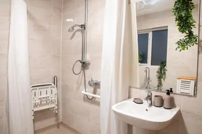 a bathroom with a sink and a shower at Elegant Bolton Home Garden Free Parking Sleeps 7 in Bolton