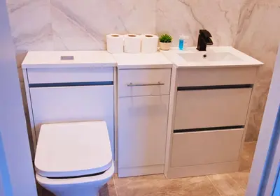 a bathroom with a white sink and a toilet at The Red Lounge House Near Anfield sleeps 14 LFC in Liverpool