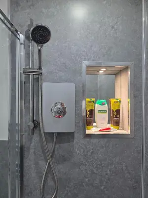 a bathroom with a shower with a mirror and a shower at Anfield 4 min walk Sleeps 7 4BR 5Bed 3Bathrooms in Liverpool