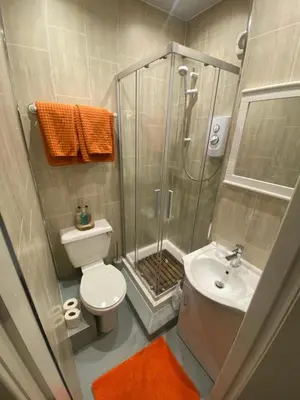 a bathroom with a shower and a toilet and a sink at Mayfield House-Private Hosted Stay with Breakfast in Blackpool