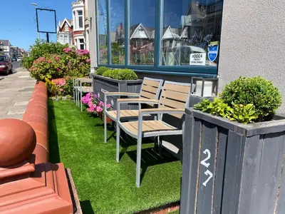 a row of chairs sitting outside of a store at Mayfield House-Private Hosted Stay with Breakfast in Blackpool