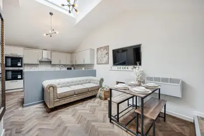 a living room with a couch and a table at Colquitt House - Air Host & Stay - 8BR Sleeps 16 in Liverpool