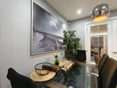 a dining room with a glass table and a picture on the wall at Hanani House in Liverpool