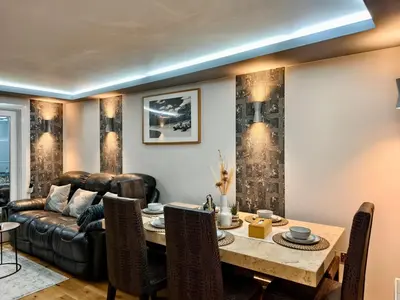 a living room with a table and a couch at Hanani House in Liverpool