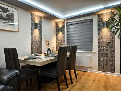 a dining room with a table and chairs and a window at Hanani House in Liverpool