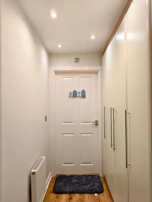 a hallway with a white door with a sign on it at Hanani House in Liverpool